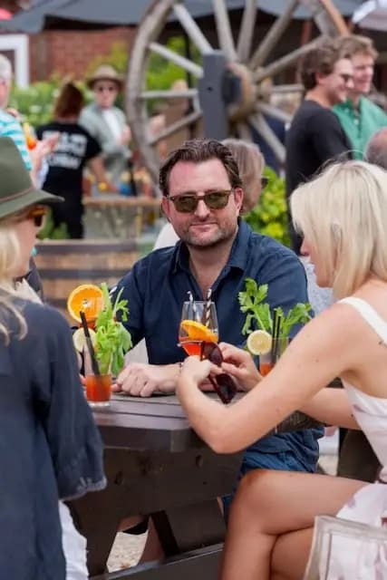 Guests raising cocktails together in the beer garden