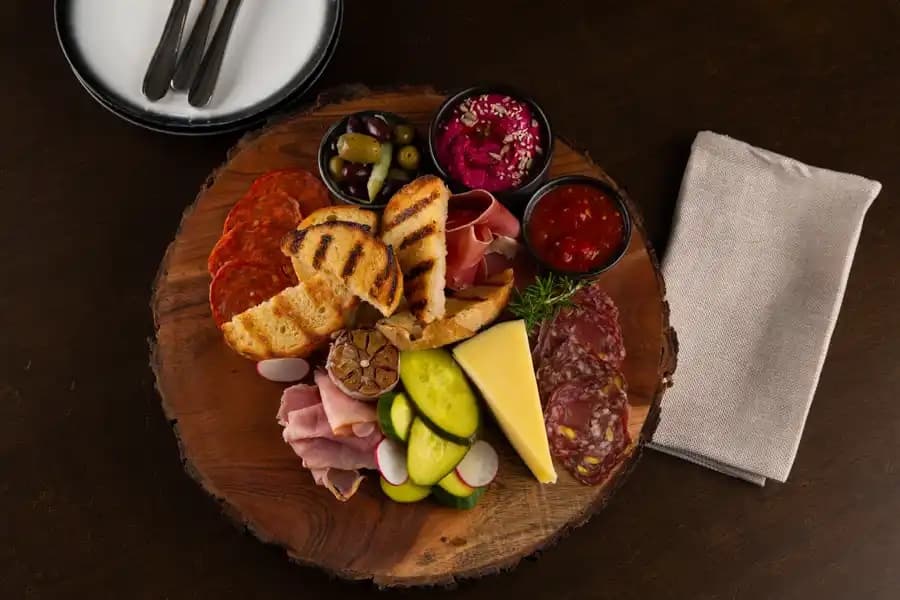 Woodfired sharing plates laid along a long table